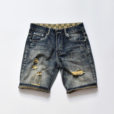 σύντομο τζιν Μοναδικό των ανδρών σε ένα σκούρο χρώμα και ψιλοκομμένο