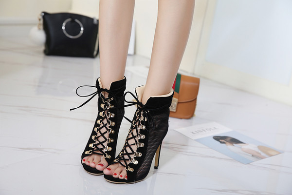 Πολλές κομψά σανδάλια των γυναικών με ψηλά τακούνια με συνδέσεις δικτύου