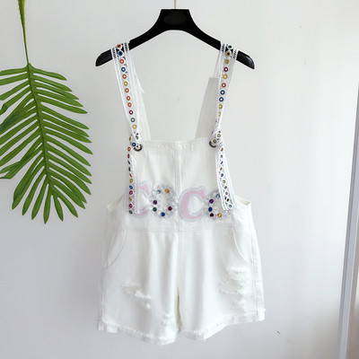 Οι γυναίκες jumpsuit με ενδιαφέρον κέντημα σε λευκό και μπλε