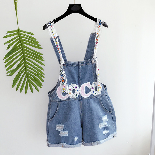 Οι γυναίκες jumpsuit με ενδιαφέρον κέντημα σε λευκό και μπλε