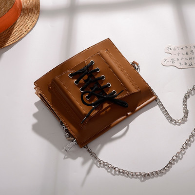 Стилна дамска чанта в четири цвята с метална дръжка и с връзки