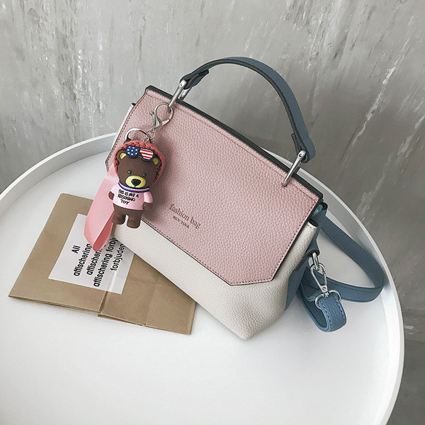 Γυναικεία τσάντα με δύο τύπους χειρολαβών και μια διακόσμηση αρκούδας