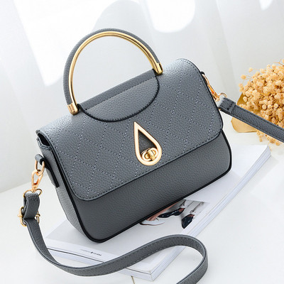 Καθημερινή συμπαγής τσάντα για γυναίκες με μη συνηθισμένη πόρπη και μακρά λαβή